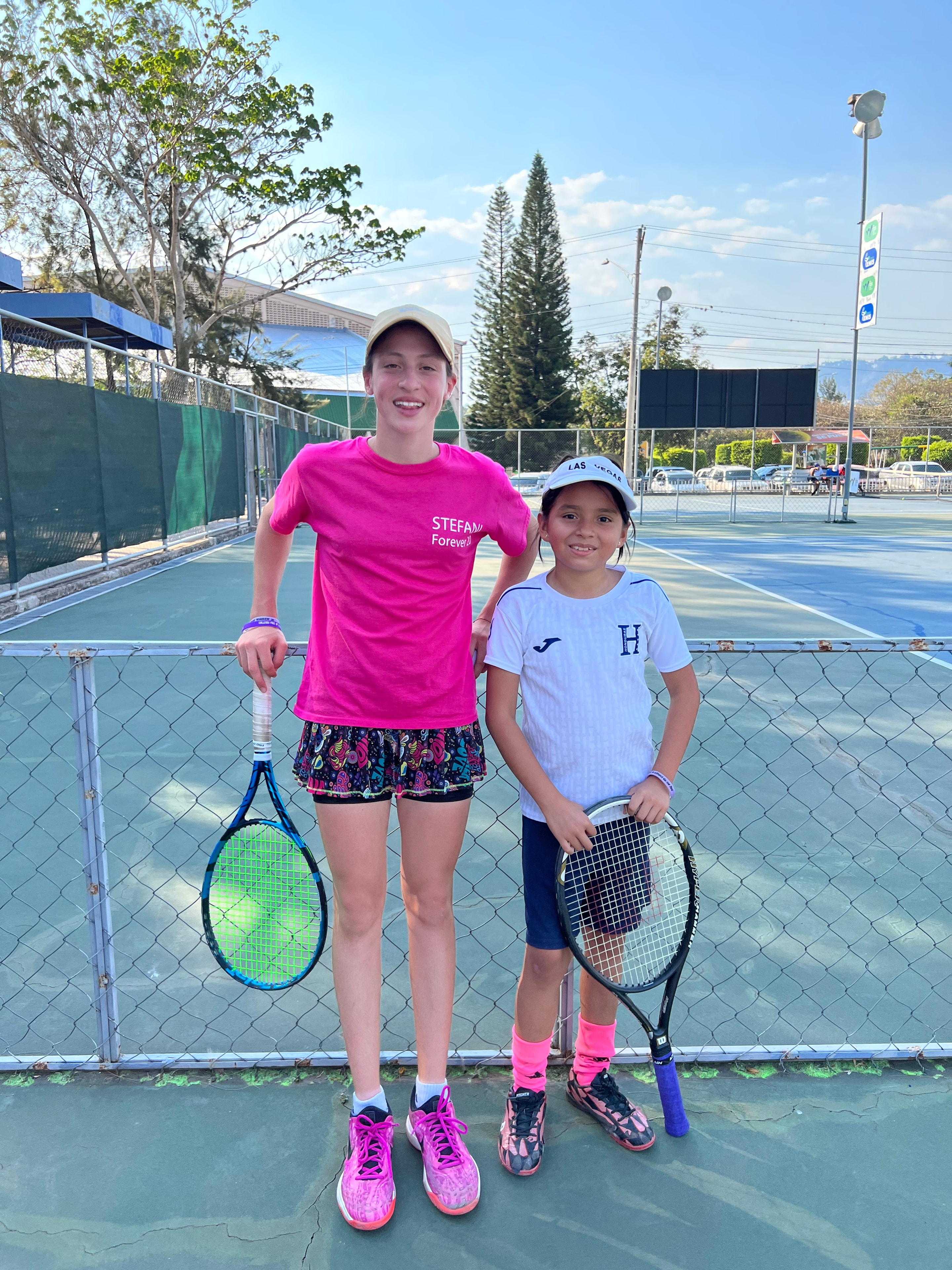 Two girls on the tennis court in Honduras